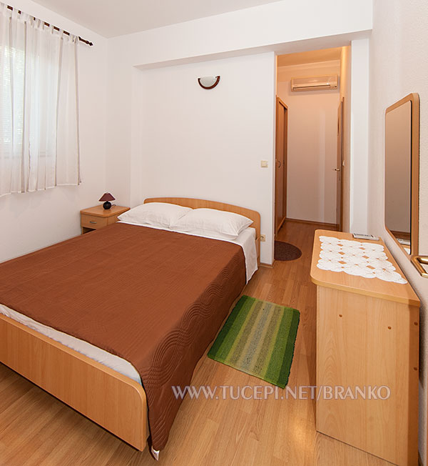 bedroom with red blanket on bed