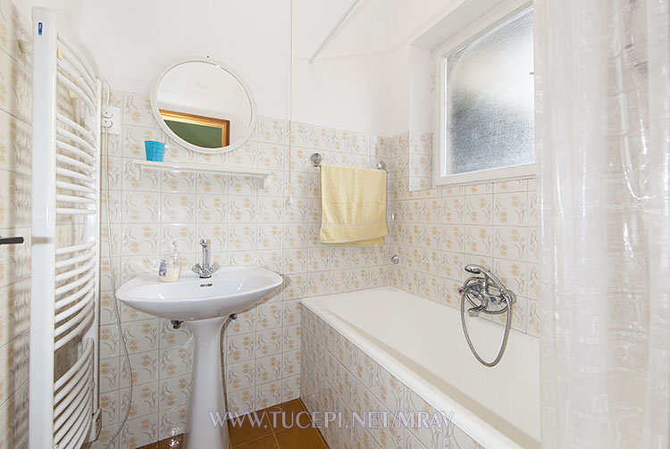 first bathroom with bathtube, sink, mirror
