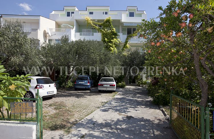 parking in front of house in olive tree shadows